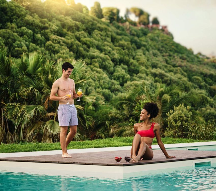 couple-relaxing-by-the-pool-in-a-tropical-resort-2025-03-07-07-33-33-HEW72ZC.jpg